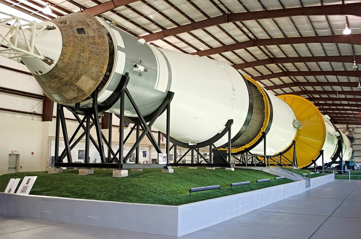 The Saturn V rocket hall at Space Center Houston with visitors walking beneath the enormous rocket