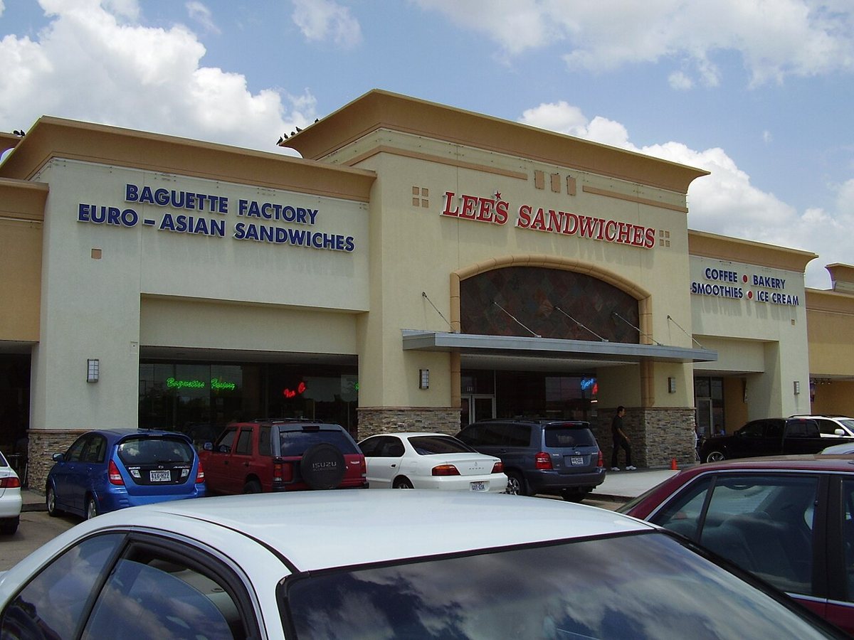 Colorful storefronts and restaurant signs along Bellaire Boulevard in Houston's Chinatown district